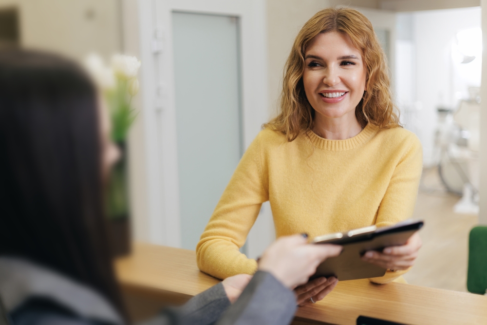 woman at front desk of dental office